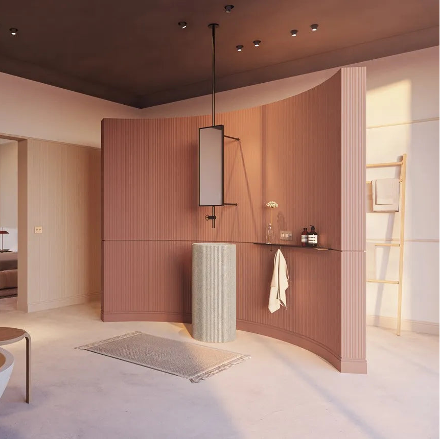 Terracotta CALANDO FLEX panels on a curved bathroom partition behind a pedestal basin and suspended mirror