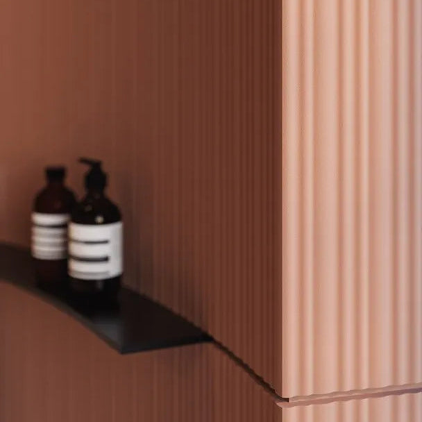 Detail of terracotta CALANDO FLEX panels following a curved wall with matching skirting at the base