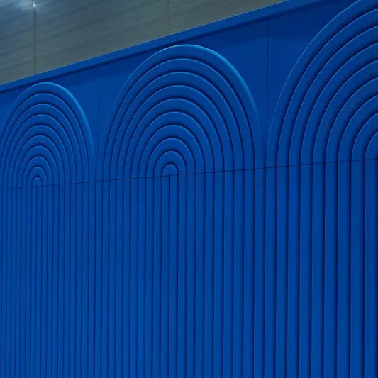 Close-up of cobalt blue CANELÉ R L ARSTYL panels with raised arches continuing into vertical ribs