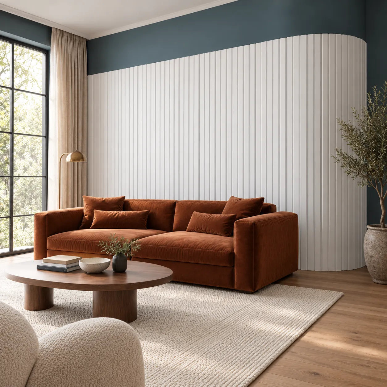 Angled view of white CANELÉ L FLEX panels following a curved wall beside a rust sofa and walnut coffee table