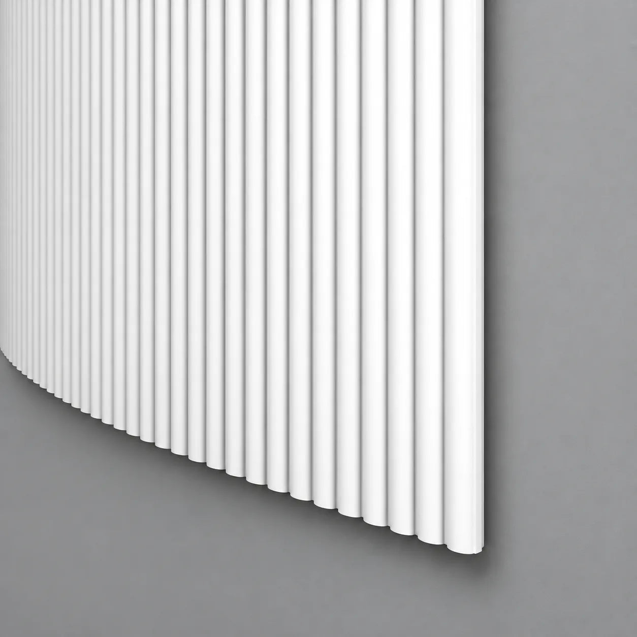White CANELÉ S FLEX wall panel with fine rounded vertical ribs and a curved profile against a grey wall