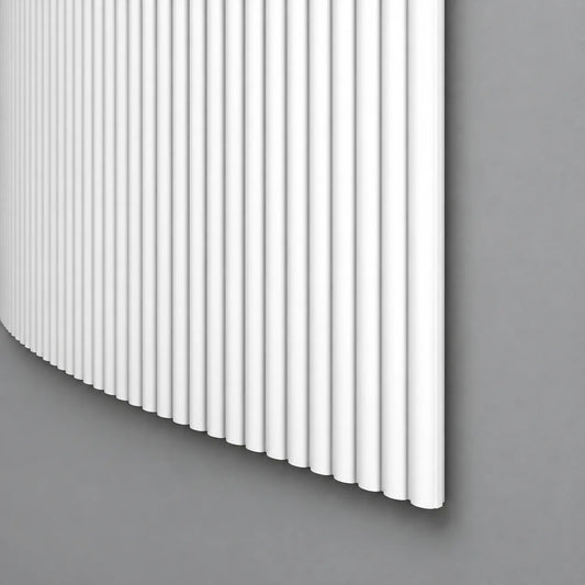 White CANELÉ S FLEX wall panel with fine rounded vertical ribs and a curved profile against a grey wall