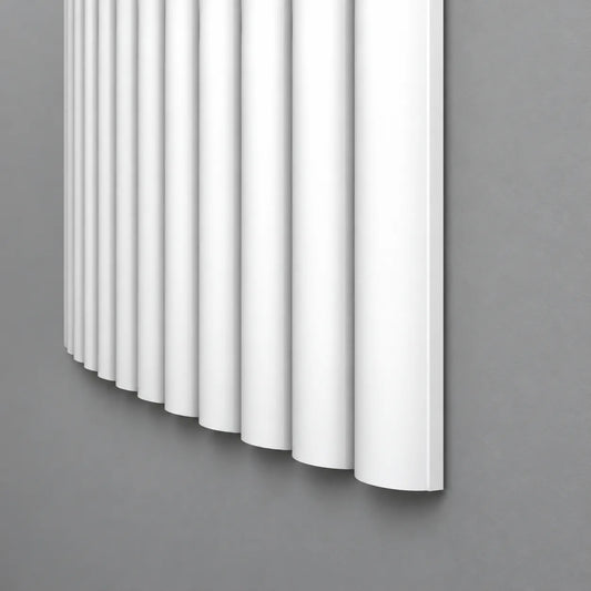 White CANELÉ XL FLEX wall panel with rounded vertical ribs and a curved profile against a grey wall