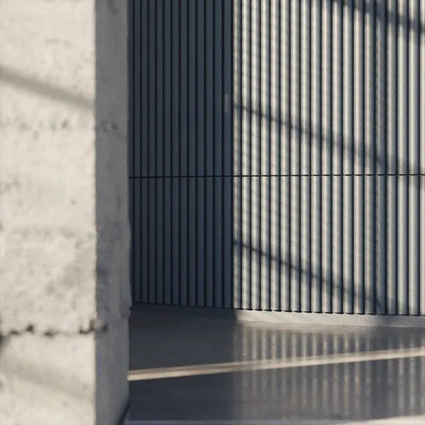 CANELÉ XL ARSTYL dark decorative wall panels with deep vertical fluting in a modern interior