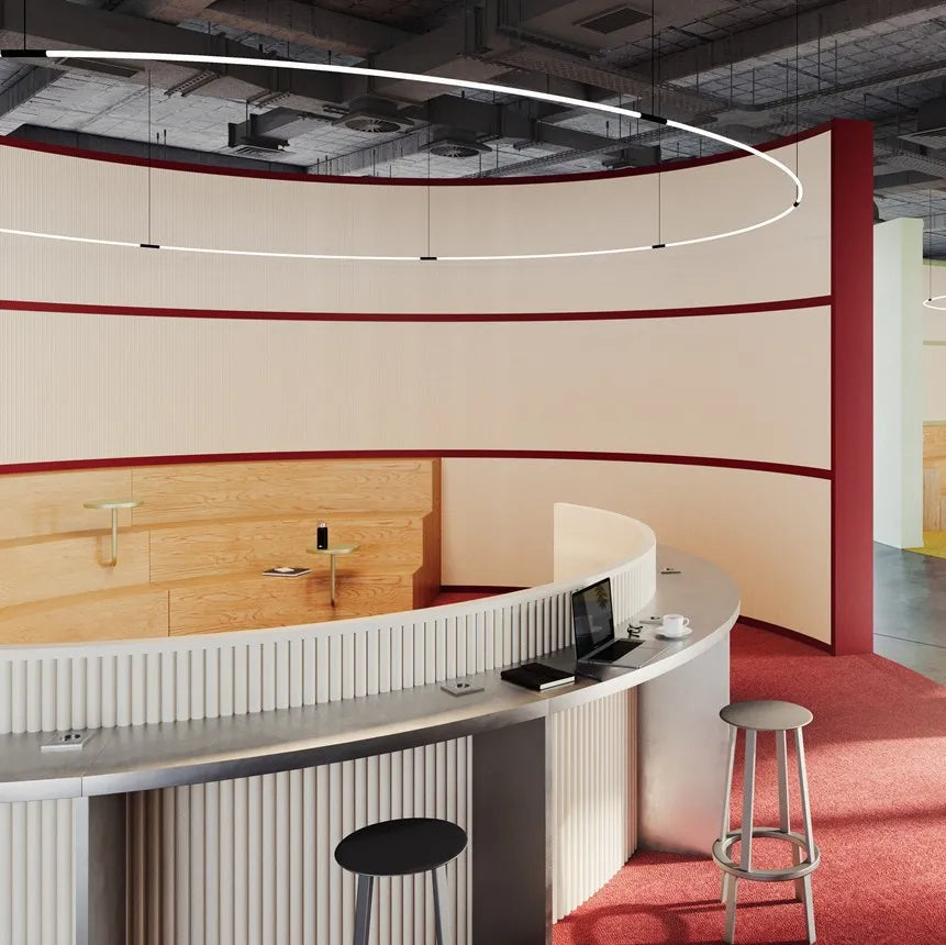 White CANELÉ XL FLEX panels on a curved office counter with a metal worktop and red carpet beneath