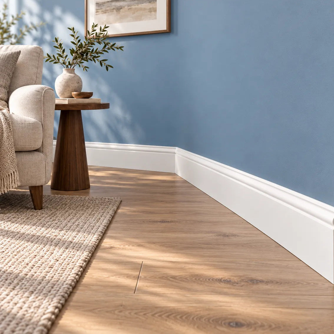 FB2F WALLSTYL skirting board installed in blue living room with wood flooring