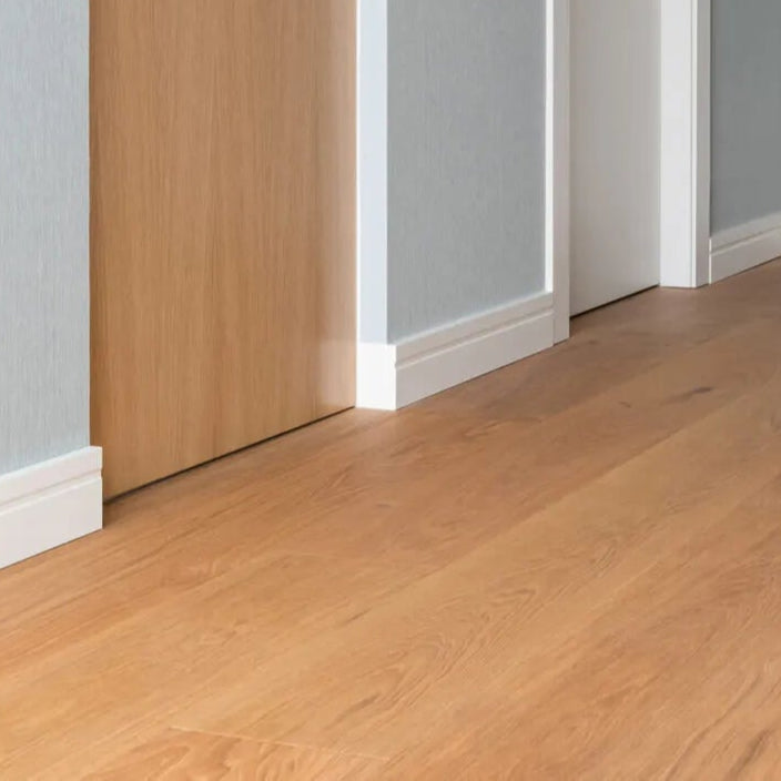 FD11 2M WALLSTYL Skirting Board in a modern hallway with gray wall and wooden floor | DecorMania UK