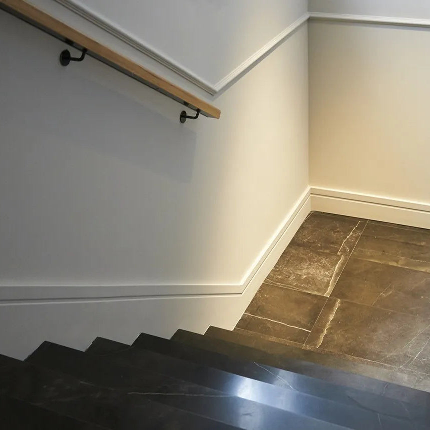 White FD20 WALLSTYL skirting board installed along a modern staircase