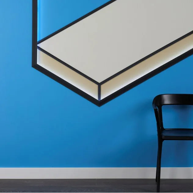White FD2S WALLSTYL skirting board in a modern blue interior with geometric wall design