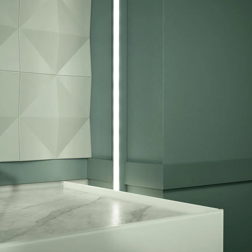 FL10 WALLSTYL skirting board used in a modern green interior with integrated lighting detail