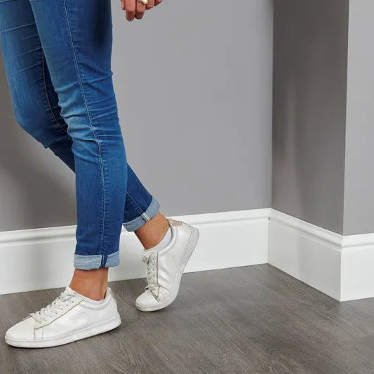 White FL17 WALLSTYL skirting board installed in a modern interior with grey walls
