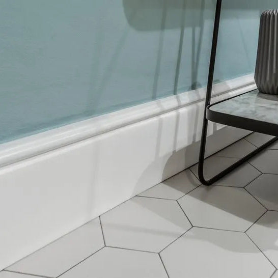 White FL17 WALLSTYL skirting board in a contemporary room with geometric floor tiles