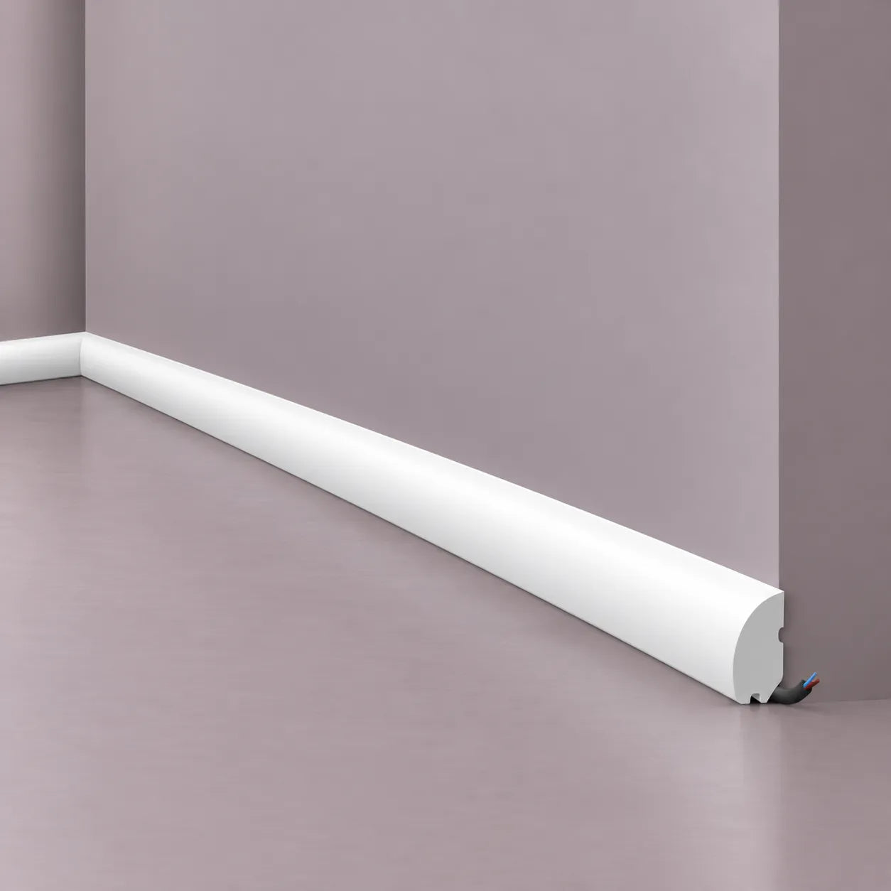 White rounded cable-concealing skirting board installed along a muted mauve wall, shown in a close-up corner detail