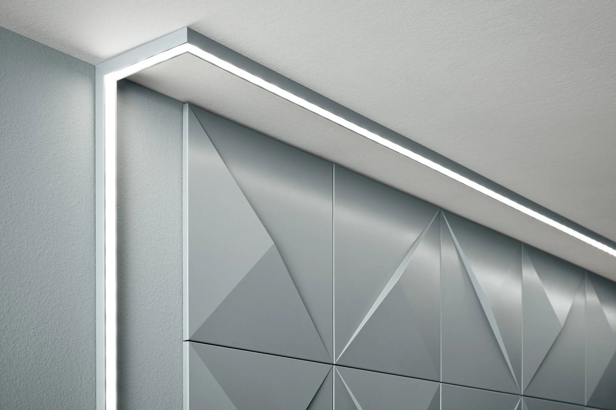 IL12 ARSTYL® 2m Ceiling Coving for LED Lighting showcasing indirect light with angled installation in a room | DecorMania UK
