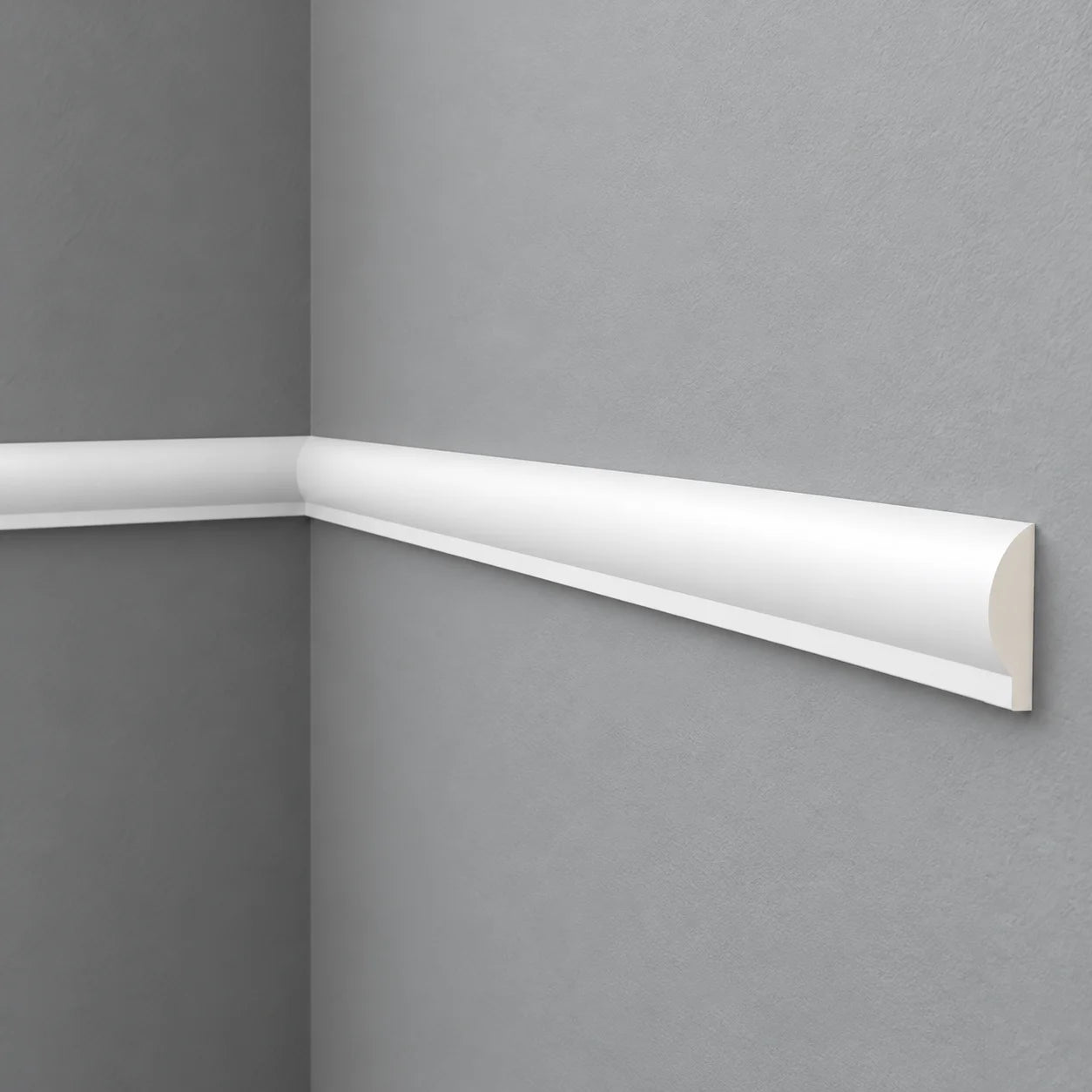 White SP1 chair rail with a rounded profile installed around a grey wall corner