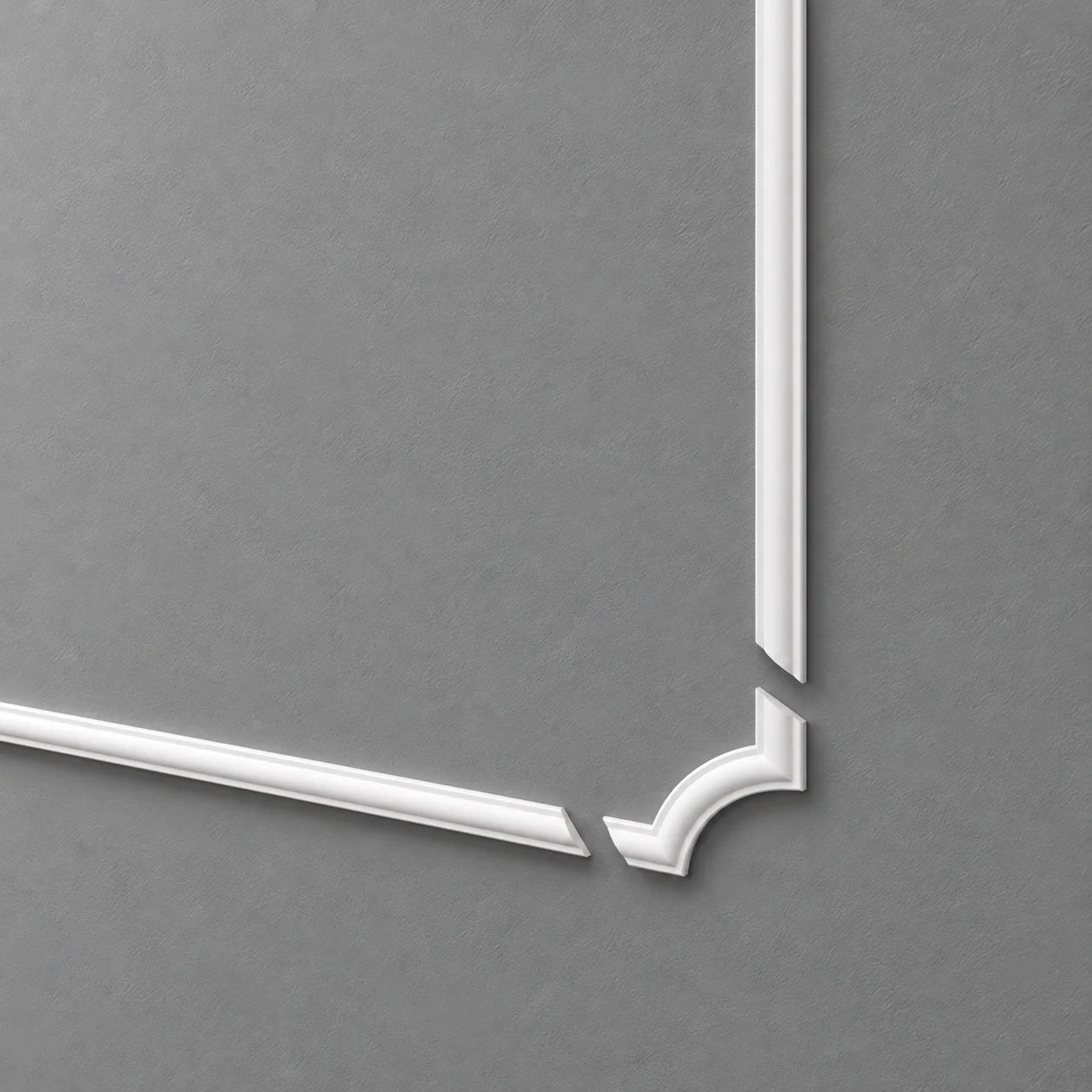 White SP2-5 decorative corner moulding with separated straight rails on a grey wall