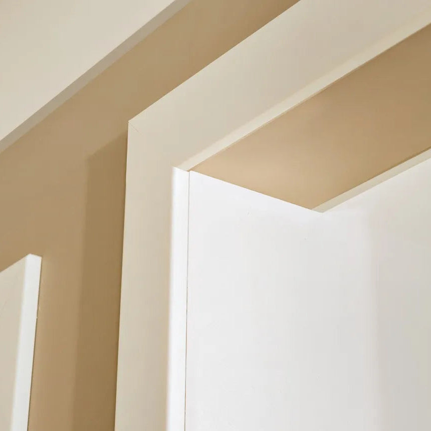 Close-up of WD4 WALLSTYL white decorative profile used as a clean modern door surround