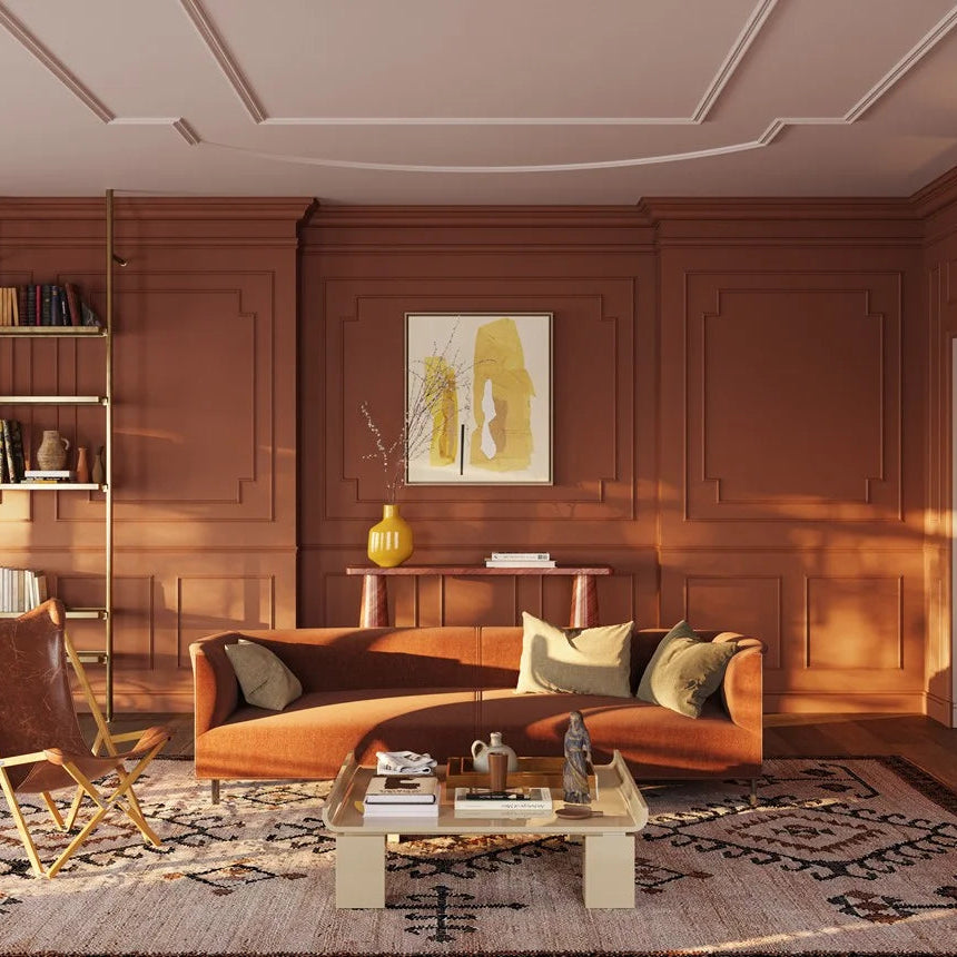 Terracotta living room with WL11 dado rail, decorative wall frames and an orange sofa