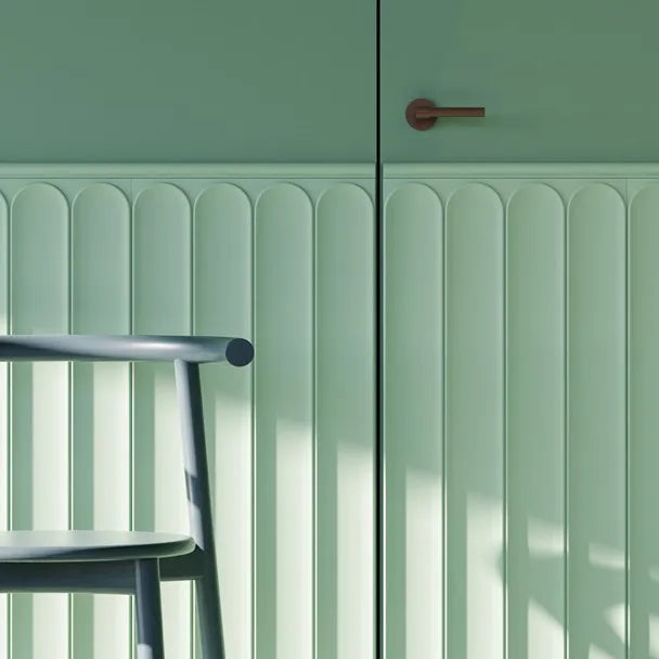 Mint green WL13 WALLSTYL chair rail above rounded wall panels continuing across a concealed door