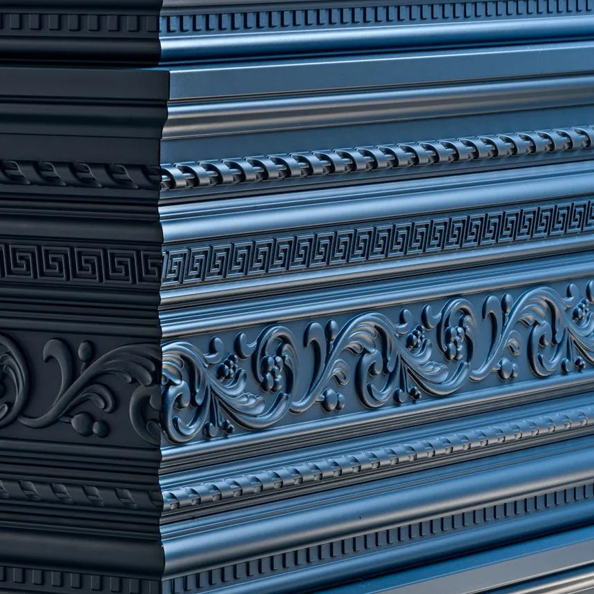 Close-up of blue Z31 Greek key moulding alongside ornate decorative trims on a bar counter