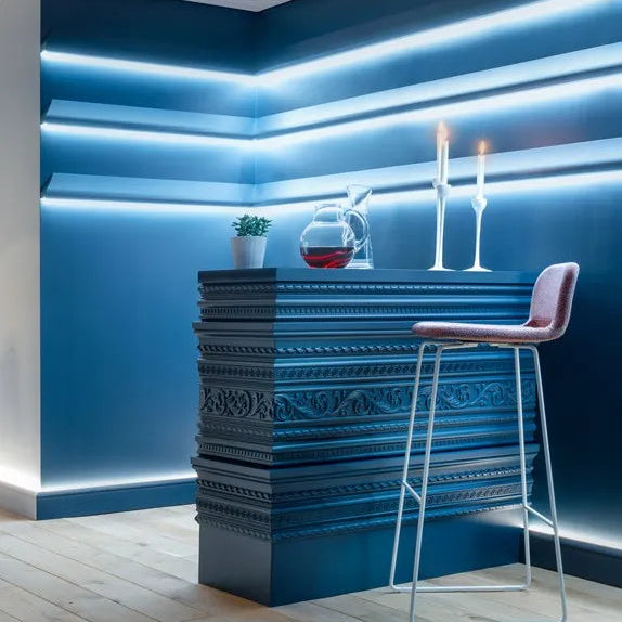 Blue home bar with Z31 Greek key moulding, illuminated shelves and a pink bar stool